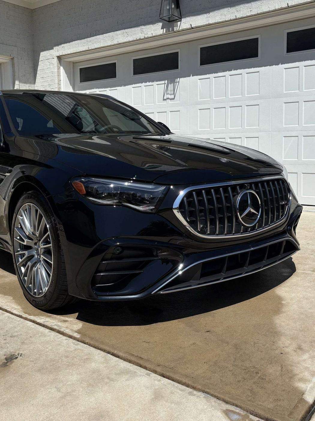 A freshly detailed car in a Cary driveway